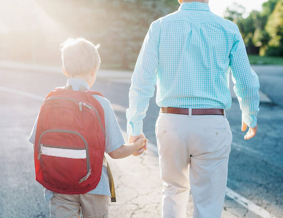 Father and son walking to school